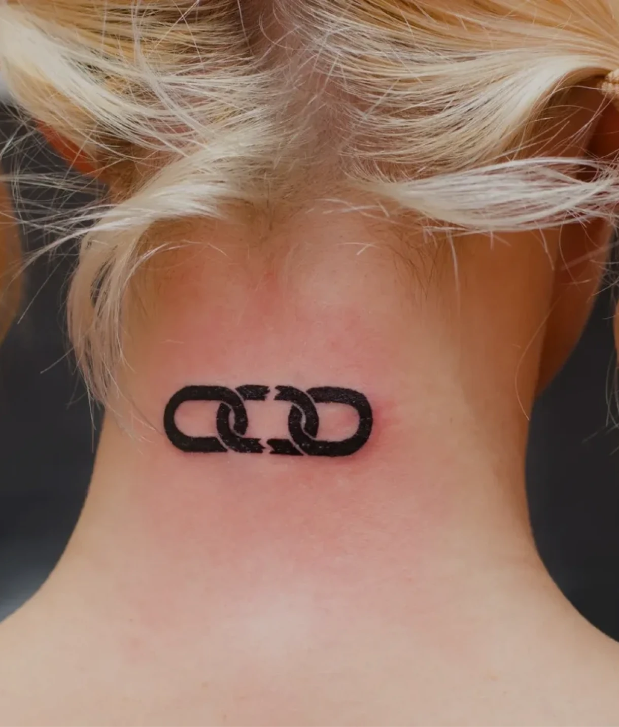 Neck tattoo of two linked chains.